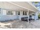 Inviting covered patio area with paved flooring, comfortable seating, and a view of the charming home exterior at 1412 Nebraska St, Orlando, FL 32803