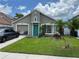 One story house with teal door, attached garage, and well-maintained lawn at 1417 Brookebridge Dr, Orlando, FL 32825