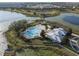 Resort-style community pool and clubhouse near a lake at 14502 Bahama Swallow Blvd, Winter Garden, FL 34787