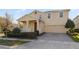 Two-story house with a red door, two-car garage, and landscaped yard at 14502 Bahama Swallow Blvd, Winter Garden, FL 34787