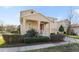 Two-story house with a red door and well-manicured landscaping at 14502 Bahama Swallow Blvd, Winter Garden, FL 34787