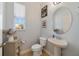 Small powder room with white pedestal sink and toilet at 14502 Bahama Swallow Blvd, Winter Garden, FL 34787