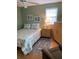 Cozy bedroom showcasing a ceiling fan and light-filled window at 1500 Gay Rd # 10C, Winter Park, FL 32789