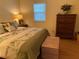 Comfortable bedroom with wooden dresser at 1500 Gay Rd # 10C, Winter Park, FL 32789