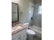 Renovated bathroom features a marble-tiled shower, updated vanity, and modern fixtures at 158 Country Club Cir, Sanford, FL 32771