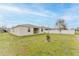 Spacious backyard features healthy green grass and is partially fenced in for privacy at 16462 Glassy Loch Loop, Clermont, FL 34714