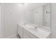 Bright bathroom with double sinks, large mirror, and modern fixtures at 16462 Glassy Loch Loop, Clermont, FL 34714