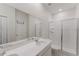 Modern bathroom with a glass-enclosed shower and double vanity at 16462 Glassy Loch Loop, Clermont, FL 34714