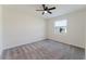 Bright bedroom with plush gray carpet, a ceiling fan, and a window offering natural light at 16462 Glassy Loch Loop, Clermont, FL 34714