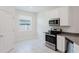 Bright kitchen featuring stainless steel appliances and white cabinets at 16462 Glassy Loch Loop, Clermont, FL 34714