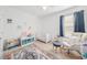 Cozy carpeted Bedroom with white furniture, including a crib and rocking chair by the bright window at 16560 Point Rock Dr, Winter Garden, FL 34787