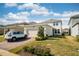 Charming, light two-story home with a paved driveway and well-manicured lawn on a sunny day at 16560 Point Rock Dr, Winter Garden, FL 34787