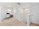 Bright upstairs hallway with neutral carpet and natural light from multiple windows at 16560 Point Rock Dr, Winter Garden, FL 34787