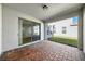 Covered patio featuring a brick-paved floor and sliding glass doors leading to the interior at 16560 Point Rock Dr, Winter Garden, FL 34787