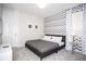 Bedroom with a queen-size bed and chevron accent wall at 1830 Sawyer Palm Pl, Kissimmee, FL 34747