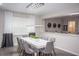 Modern dining room with white table, gray chairs, and statement chandelier at 1830 Sawyer Palm Pl, Kissimmee, FL 34747