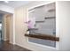 Modern entryway with geometric wall art and wood accent shelf at 1830 Sawyer Palm Pl, Kissimmee, FL 34747