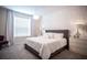 Main bedroom with king-size bed, gray headboard, and textured wall at 1830 Sawyer Palm Pl, Kissimmee, FL 34747