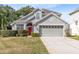 Two-story house with gray siding, red door, and attached garage at 1834 Duffy Ct, Lake Mary, FL 32746