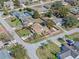 Aerial view of a well-kept single-story home surrounded by landscaped lawns and trees at 1971 Urbana Ave, Deltona, FL 32725