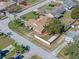 Aerial view of the home featuring a large, fenced yard, mature trees, and lush landscaping at 1971 Urbana Ave, Deltona, FL 32725