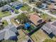 An overhead shot showcasing the property's fenced backyard, mature trees, and charming picnic shelter at 1971 Urbana Ave, Deltona, FL 32725