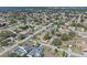 An aerial of a tidy residential area presenting cozy homes and neatly arranged streets amid verdant scenery at 1971 Urbana Ave, Deltona, FL 32725