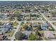 Neighborhood aerial shot featuring various homes with pools, solar panels, and beautiful, established landscaping at 1971 Urbana Ave, Deltona, FL 32725