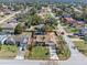 Aerial view of a single-story home with mature landscaping, surrounded by lush greenery and neighborhood streets at 1971 Urbana Ave, Deltona, FL 32725