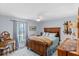 Cozy bedroom featuring a wooden bed frame, light blue walls, and a ceiling fan at 1971 Urbana Ave, Deltona, FL 32725