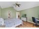 Bedroom features vaulted ceiling, wood floors, and is painted a calming green at 1971 Urbana Ave, Deltona, FL 32725