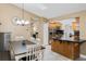 Bright dining area adjacent to the kitchen, featuring a stylish chandelier and ample space for entertaining at 1971 Urbana Ave, Deltona, FL 32725