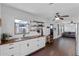 Open concept kitchen with butcher block countertops, white cabinets, and stainless steel sink at 1971 Urbana Ave, Deltona, FL 32725