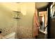 Bathroom featuring a toilet, built in storage shelves and tiled walls at 214 E 18Th St, Sanford, FL 32771