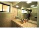 Bathroom with tiled walls, mirror, and tiled countertops at 214 E 18Th St, Sanford, FL 32771