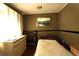 Bedroom featuring a bed, dresser, mirror and a window providing natural light at 214 E 18Th St, Sanford, FL 32771