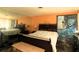 View of the bedroom with bed, dresser, art piece and a large mirror at 214 E 18Th St, Sanford, FL 32771