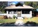 Charming single-story home with a cozy front porch and well-maintained landscaping at 214 E 18Th St, Sanford, FL 32771