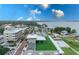 Beautiful aerial view features a rooftop patio, pool, and nearby lake under a blue sky with white clouds at 214 N New Hampshire Ave, Tavares, FL 32778