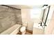 Bathroom featuring tiled shower/tub, toilet, and vanity sink at 214 N New Hampshire Ave, Tavares, FL 32778