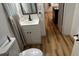 Small bathroom with white vanity and light wood floors at 214 N New Hampshire Ave, Tavares, FL 32778