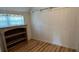 Small bedroom with light wood floors and built-in shelving at 214 N New Hampshire Ave, Tavares, FL 32778