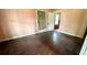 Simple bedroom with hardwood floors and an adjoining closet at 214 N New Hampshire Ave, Tavares, FL 32778