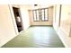 Bright bedroom featuring painted wood floors and double hung windows at 214 N New Hampshire Ave, Tavares, FL 32778