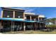 Exterior view of a multi-story restaurant with outdoor seating and a blue awning at 214 N New Hampshire Ave, Tavares, FL 32778