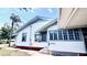 Classic home with front-facing window, trimmed in blue, offering light-filled living spaces at 214 N New Hampshire Ave, Tavares, FL 32778