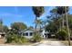 Single story home with light-colored siding and palm trees at 214 N New Hampshire Ave, Tavares, FL 32778