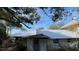 Rear view of the house, showing metal roof and stonework at 214 N New Hampshire Ave, Tavares, FL 32778