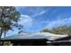 Metal roof of a house, with trees and sky visible at 214 N New Hampshire Ave, Tavares, FL 32778