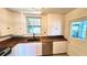 Updated kitchen featuring white cabinets, stainless steel appliances, and wooden countertops at 214 N New Hampshire Ave, Tavares, FL 32778